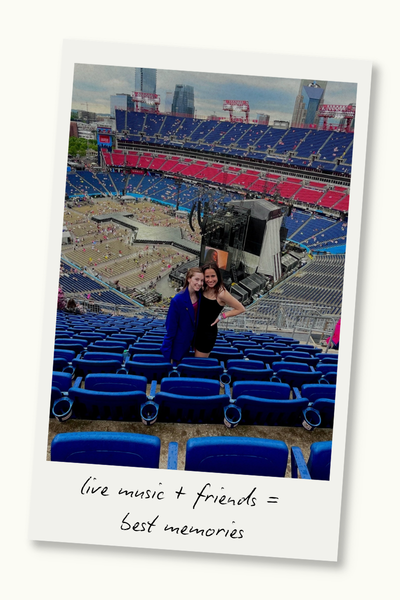 Two women in a stadium before a concert beings. A Polaroid frame surrounds the photo, and text on the frame reads "live music + friends = best memories."